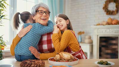 Family cuddling and preparing to eat a holiday dinner